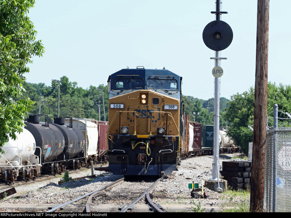 CSX 308 outside the yard office with a southbound train